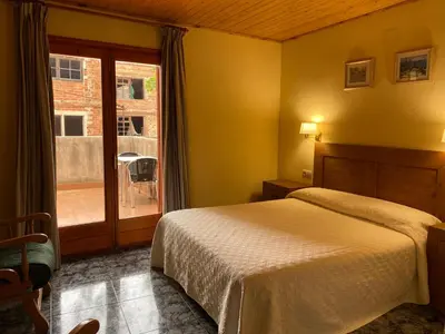 Cama o camas de una habitación en Hotel Rural Cal Amadeu