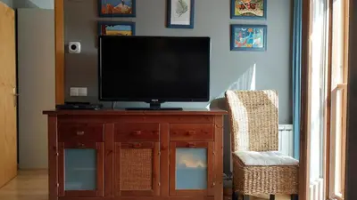 Una televisión o centro de entretenimiento en Apartamento en Villanua La Espata